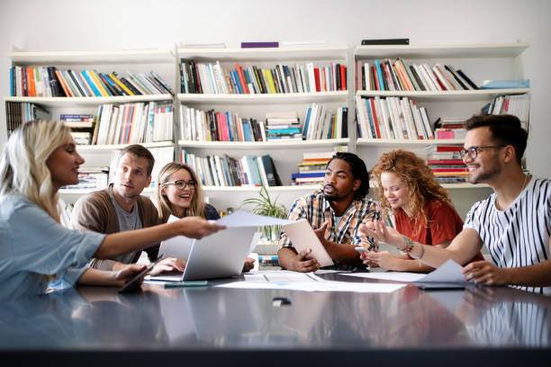 istock Creative brainstorming. Happy business people, designers, architects working as a team in office 1303454110
