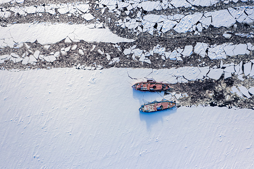 Aerial view of icebreakers on Vistula river crush ice, aerial view of Poland