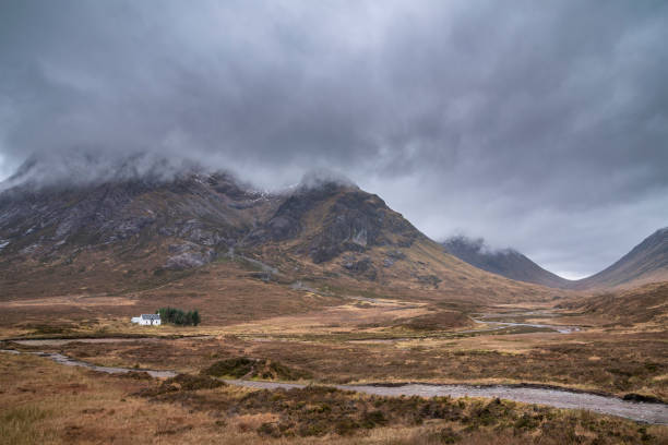 istock Majestic landscape image view down Glencoe Valley in Scottish Highlands with mountain ranges in dramatic Winter lighting 1303454294