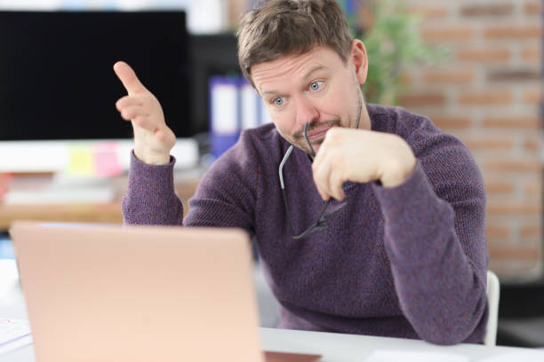 istock Surprised man looks at laptop screen in office 1303455379
