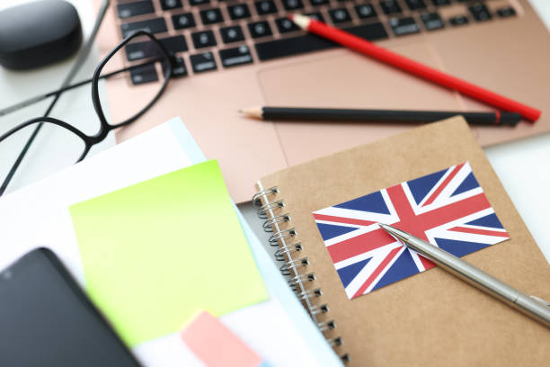 istock Notebooks, pens and laptop are on table 1303455421