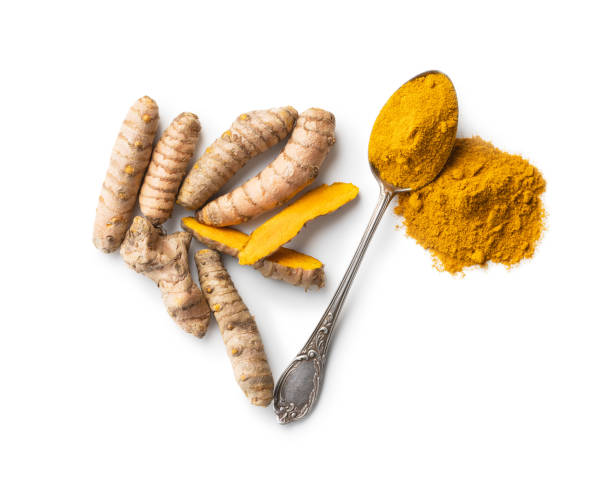 istock Indian turmeric powder and root. Turmeric spice. Ground turmeric 1303456150