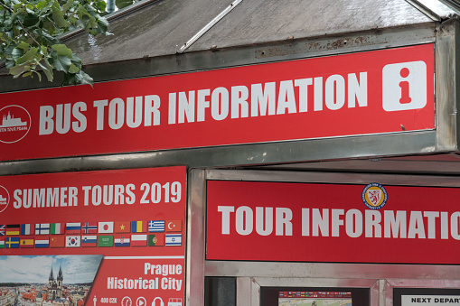 Prague, Czech Republic - July 25, 2020: Red signage of a Bus Tour Information Point in the Czech capital city