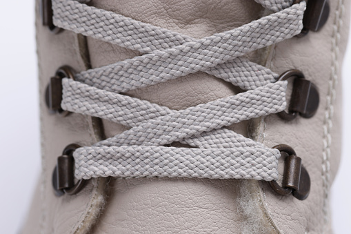Beige leather boot with laces up. Winter shoes concept