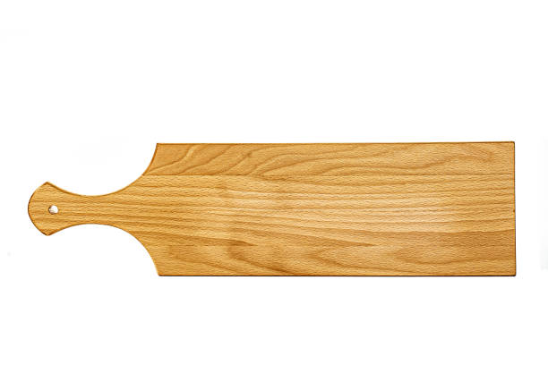 istock Old stained clean empty rectangular wooden cutting board isolated on white in an oblique low angle view for food placement 1303457539