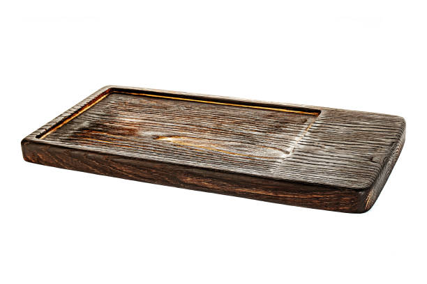 istock Dark brown wooden tray isolated with white background. 1303457579