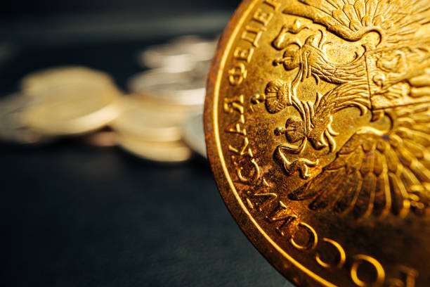istock Russian rouble coin on dark background close up 1303457644