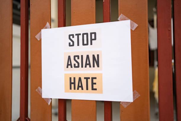 Stop Asian Hate sign was attached on the house fence Stop Asian Hate sign was attached on the house fence furious stock pictures, royalty-free photos & images