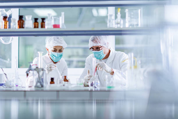 istock Senior chemists working on poisonous liquid in a laboratory. 1303460002