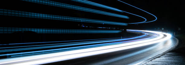 istock blue car lights at night. long exposure 1303460472