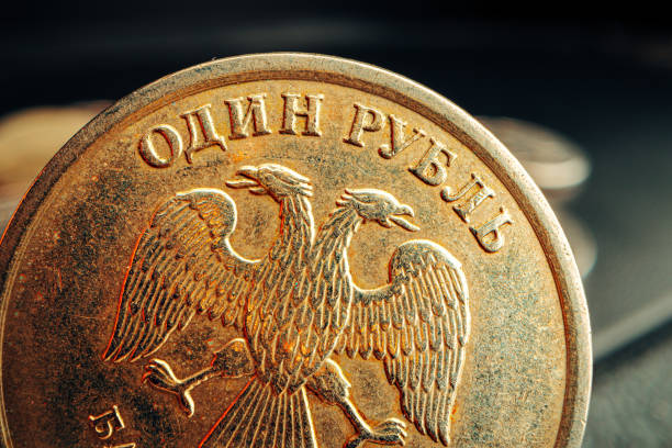 istock Russian rouble coin on dark background close up 1303460521