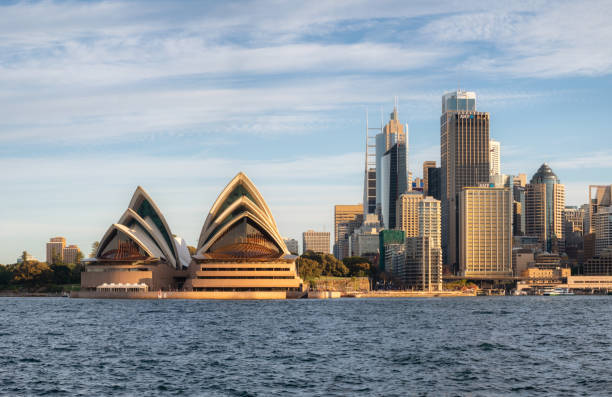 Sydney Australia - August 5, 2017: A bright afternoon in Sydney, New South Wales, and this is the view looking across the waters of Sydney Harbour towards the iconic shape of the city's Opera House.