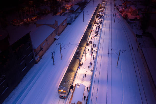 Passengers board the train on the platform. Top view. night landscape.