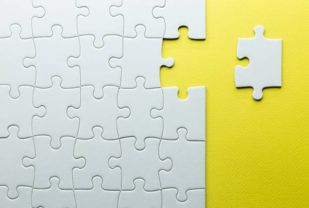 istock missing piece to complete a puzzle, white pieces on a yellow background with texture.teamwork 1303461890