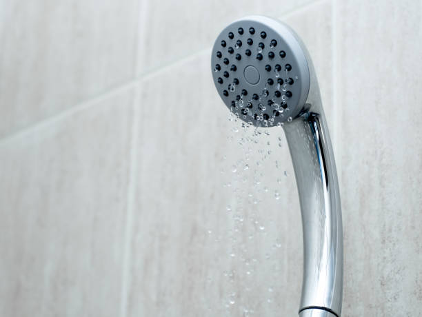 shower head with low water stream. broken shower in the bathroom - compressed imagens e fotografias de stock