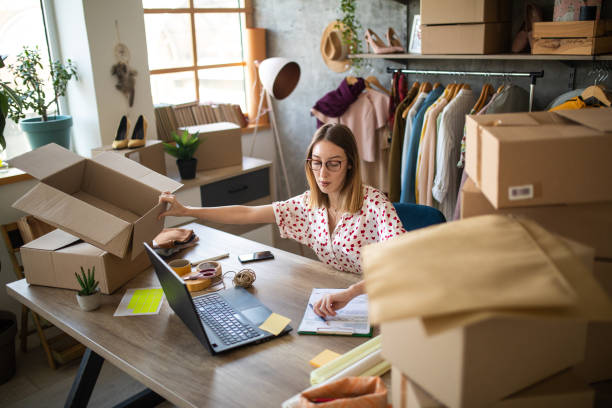 istock Female entrepreneur preparing new orders for online customers 1303466070