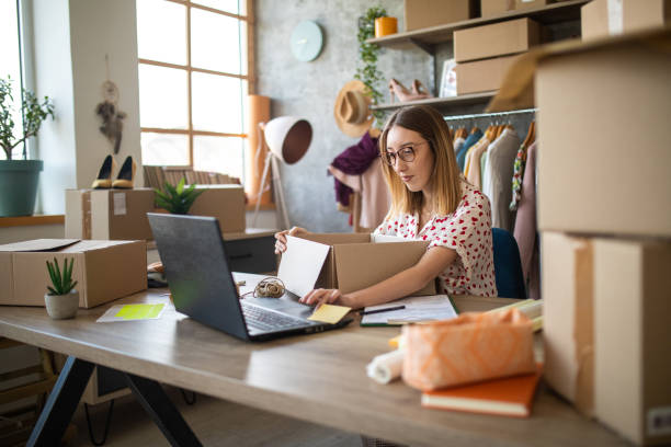 istock Female entrepreneur preparing new orders for online customers 1303466176