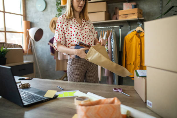 Female entrepreneur preparing new orders for online customers
