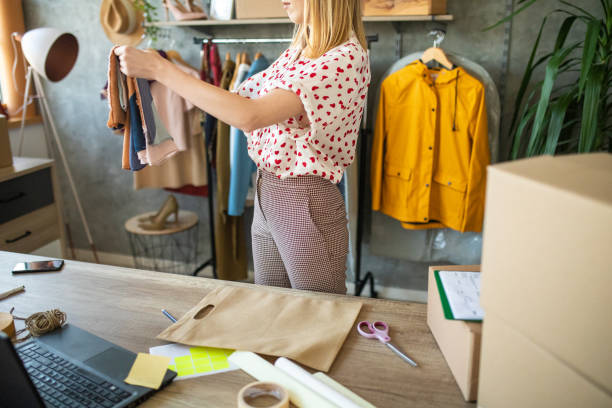 istock Successful small business owner working in her e-commerce clothing store 1303466433