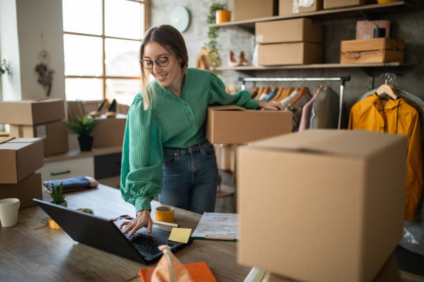 Female entrepreneur preparing new orders for online customers