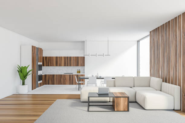 istock White living room with sofa near window and kitchen set on background 1303467066