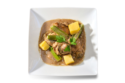 Muamba Chicken (Muamba De Galinha). aromatic Angola Chicken Stew in white dish isolated on white top view flat lay