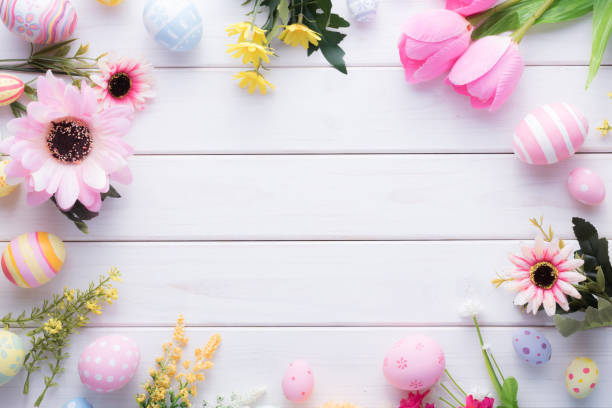 istock Happy Easter day colorful eggs and flower decoration on wood background with copy space 1303468894