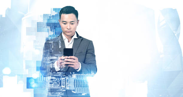 istock Asian businessman using smartphone in city 1303469452