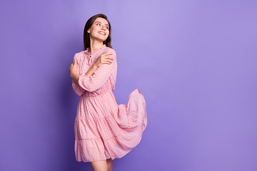 Photo of adorable positive person look empty space hug shoulders wear retro isolated on purple color background.