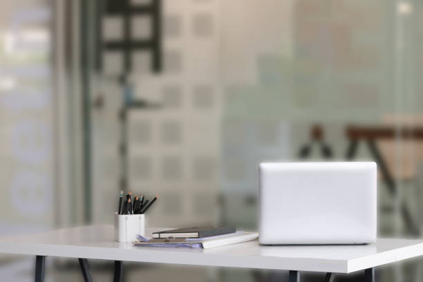 istock Laptop on desk with blur background. Workspace, office room concept 1303470785