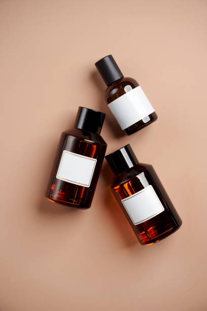 istock Essential oil bottles on pastel color background with copy space 1303470812