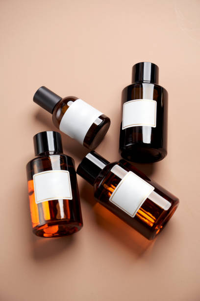 istock Essential oil bottles on pastel color background with copy space 1303470831
