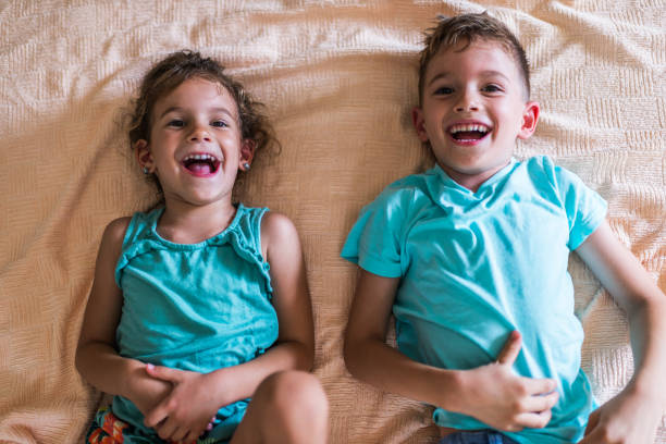 istock Beautiful children playing on the bed 1303470909