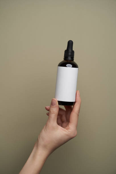 istock Essential oil bottles on pastel color background with copy space 1303470912