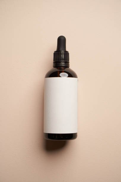 istock Essential oil bottles on pastel color background with copy space 1303470919