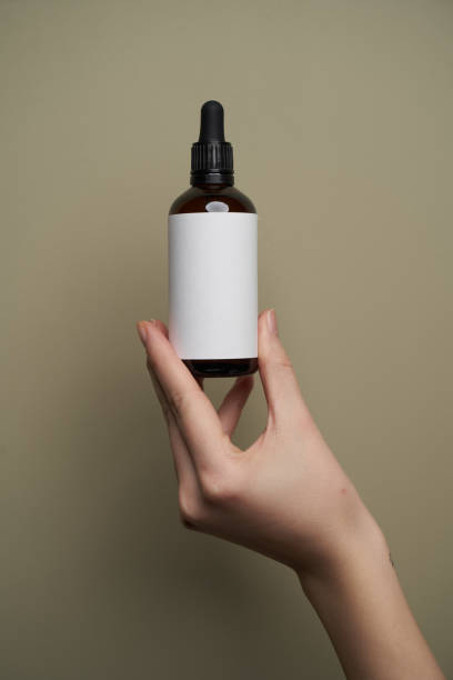 istock Essential oil bottles on pastel color background with copy space 1303470930