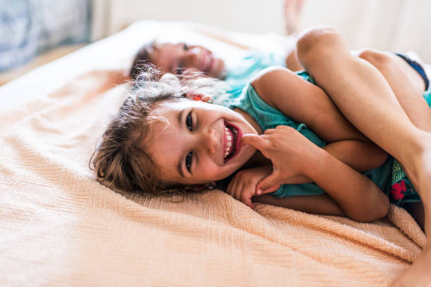 istock Beautiful children playing on the bed 1303471265