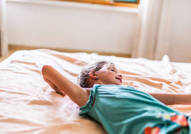 istock Beautiful girl playing on the bed 1303471919
