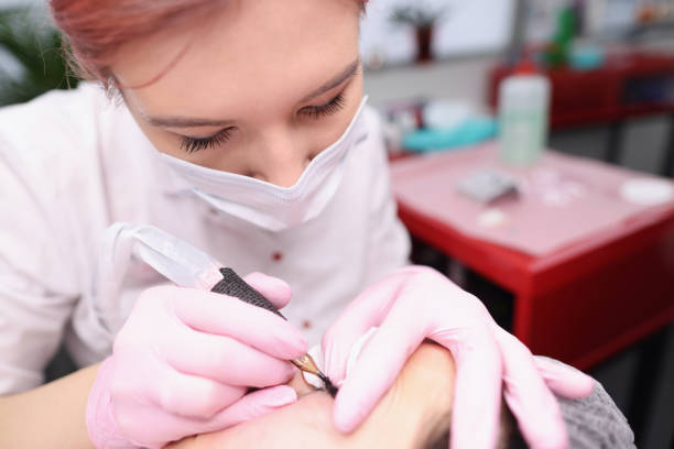 istock Master cosmetologist makes permanent eyelid tattoo in beauty salon 1303471979