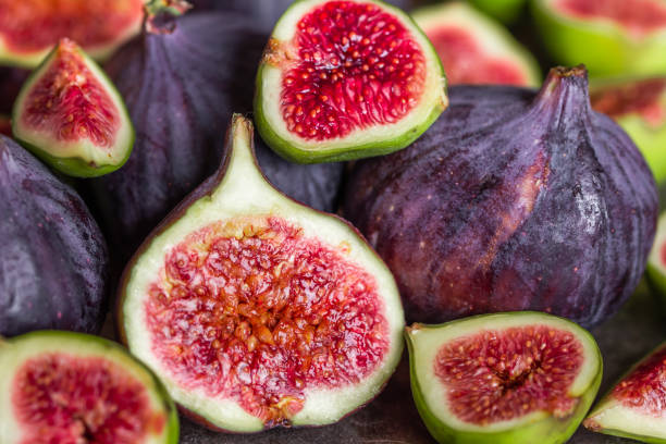 istock Fresh juicy figs fruit. Fig slice, closeup. 1303472248
