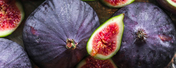 istock Fresh fig fruits. Whole and sliced figs, background. 1303472341