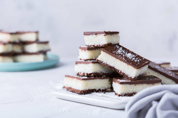 istock Organic raw vegan coconut bars with chocolate on kitchen table 1303474439