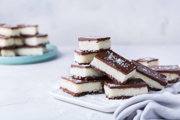 istock Organic raw vegan coconut bars with chocolate on kitchen table 1303474519