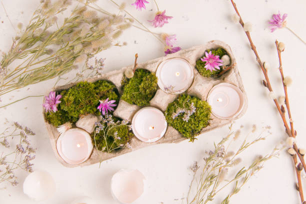 istock diy for easter. shell from eggs with candles on a white background with field flowers 1303475209