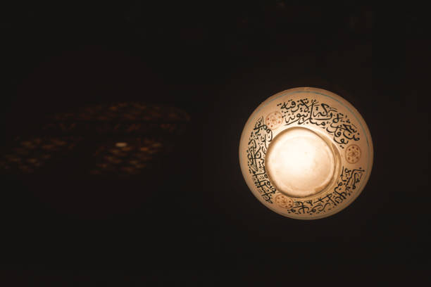 lantern with Quran verses at the Sultan Hassan Mosque , also known as \