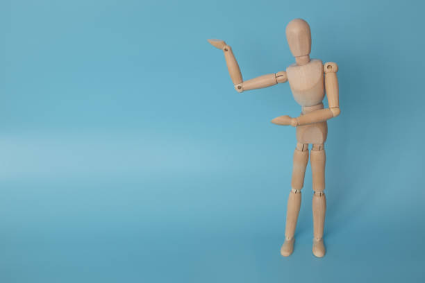 istock Human mannequin made of wood on a blue background. 1303476085
