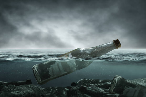 istock Glass bottle in the ocean 1303476334