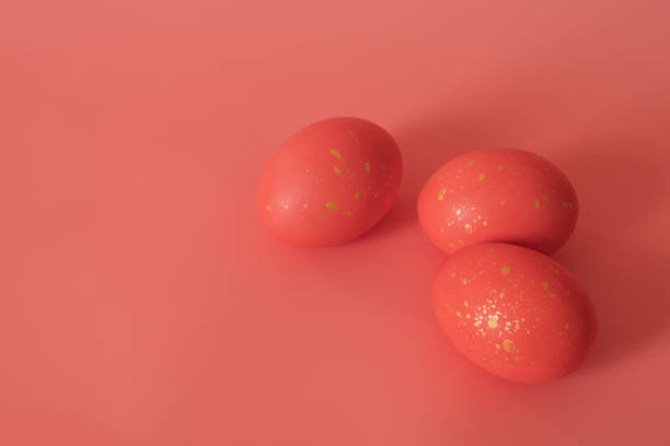 istock Painted eggs on a pink background. Pink eggs with gold spots. Easter decorations. 1303476437