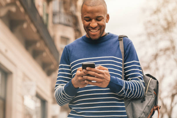 istock Young man using phone for video chat while walking in the street. 1303478299