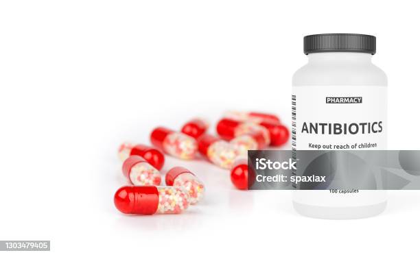 Pharmacy Bottle With Red Pills Isolated On A White Stock Photo - Download Image Now - Antibiotic, White Background, Cut Out